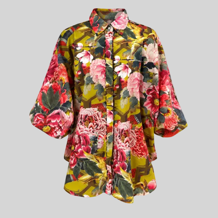 Butterfly sleeve, button-up shirt with a bold floral print against a plain white background.