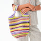 Person holding a colorful striped bag with a white background