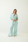 Woman wearing a striped pajama set on a white background