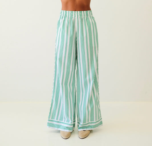 Green and white striped pants on a plain background