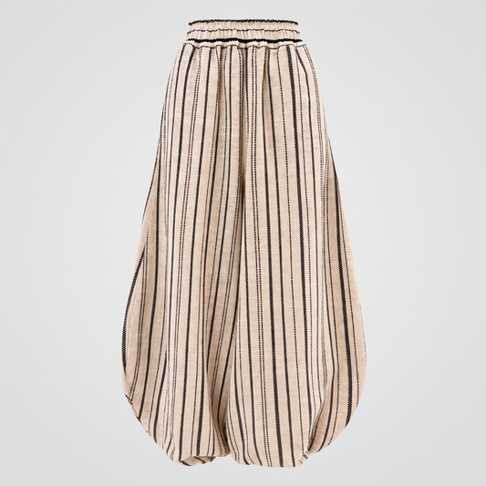 A pair of beige wide-leg harem pants with vertical black stripes, featuring an elastic waistband.