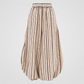 A pair of beige wide-leg harem pants with vertical black stripes, featuring an elastic waistband.