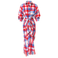 A red, white, and blue plaid long-sleeve shirt dress with a tie waist and fringed hem, shown on a plain white background.