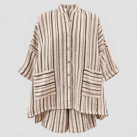 A beige and black vertically striped button-up shirt jacket with three-quarter sleeves and two front patch pockets, shown on a plain white background.
