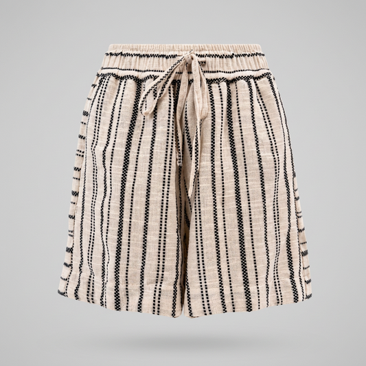 A pair of women's shorts featuring a vertical black dotted stripe pattern on a textured cream-colored fabric, with an elastic waistband and a matching drawstring tie.