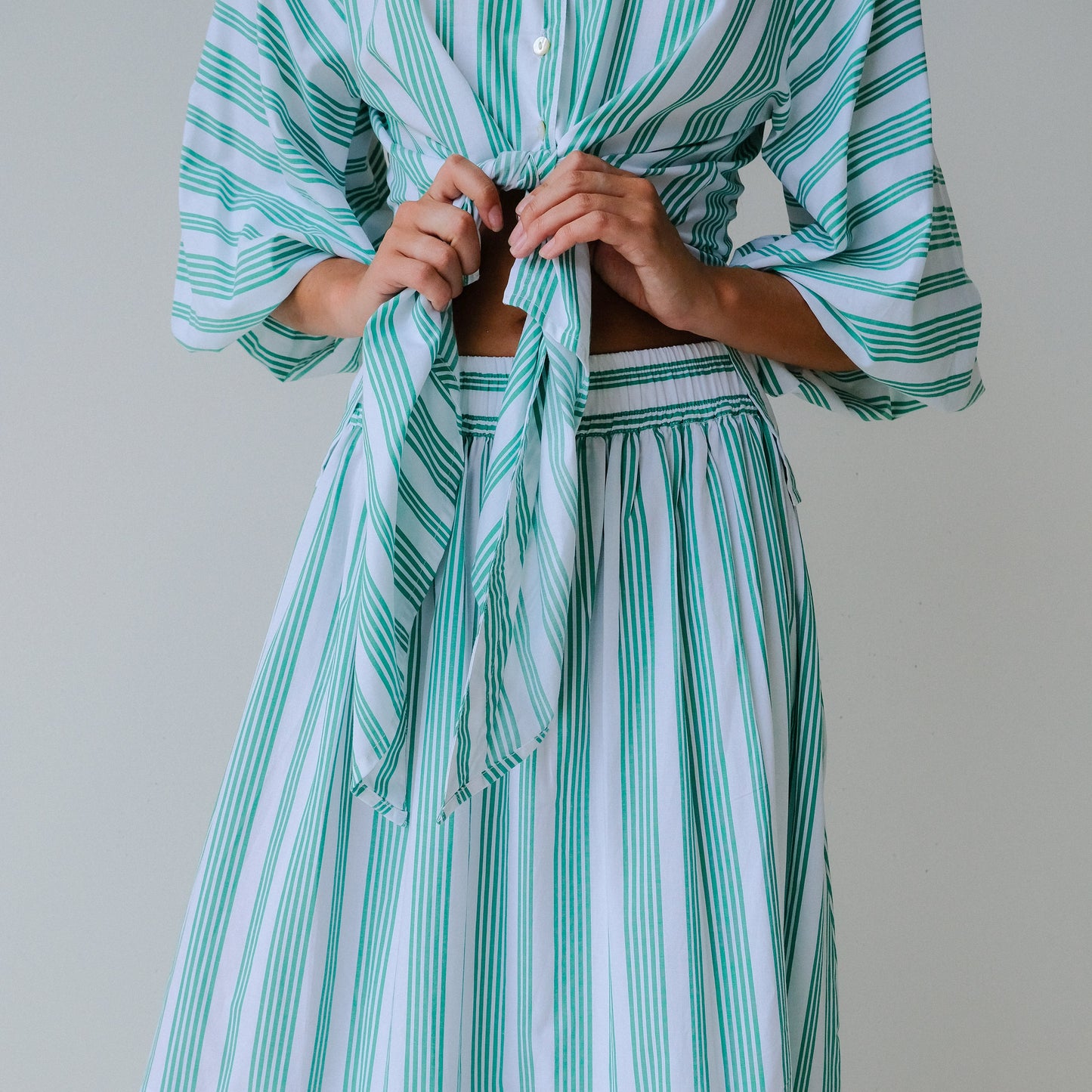 Green and white striped dress with a plain background