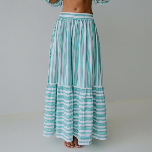 Green and white striped skirt on a plain background