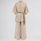 A beige and brown vertically striped two-piece set featuring a short-sleeve button-front top with a tie belt and matching wide-leg pants, shown on a plain white background.
