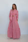 A red and white gingham tiered maxi dress with a wrap-style long-sleeve top and side pockets, shown on a model against a white background.