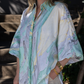 Person wearing a colorful patterned shirt with a blurred background