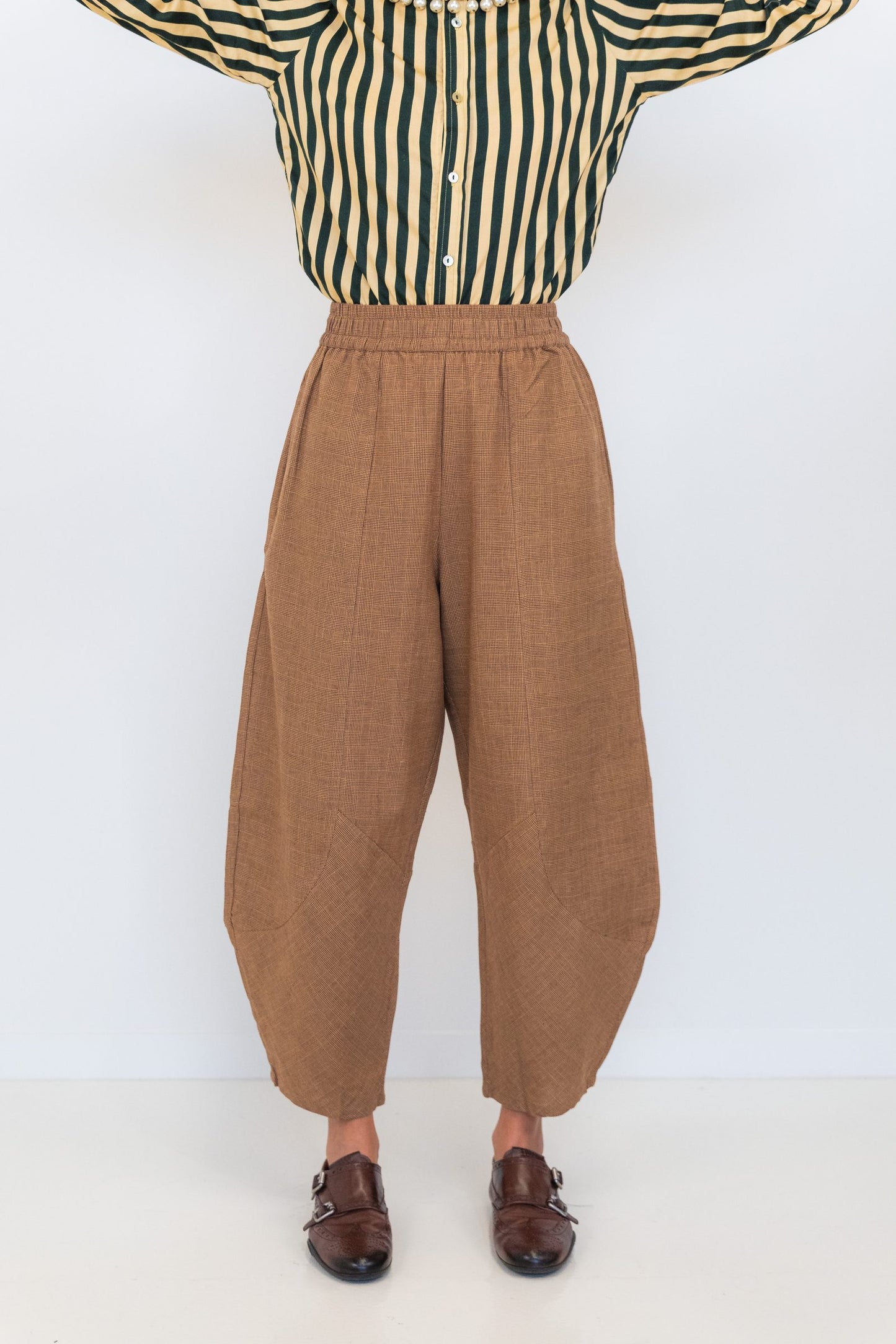 Front view of Chocolate Prince of Wales barrel pants showing the brown check fabric and tapered barrel shape.