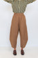 Front view of Chocolate Prince of Wales barrel pants showing the brown check fabric and tapered barrel shape.