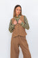 Model wearing Chocolate Prince of Wales barrel pants with a matching check vest and striped shirt.