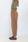 Side view of Chocolate Prince of Wales barrel pants showing the relaxed curved-leg silhouette.