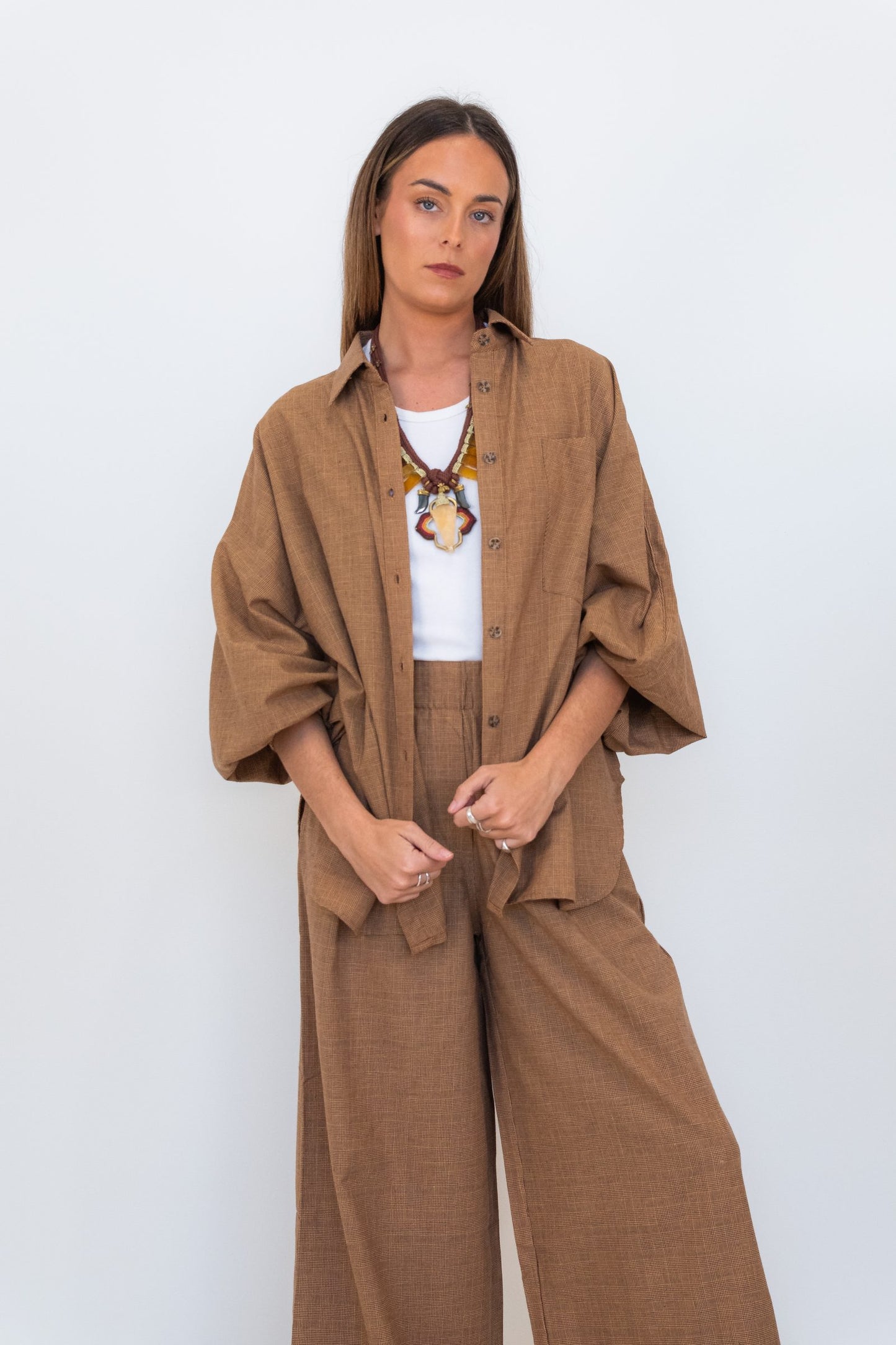 Full-length model wearing the Chocolate Prince of Wales Butterfly Shirt with matching wide-leg check trousers.