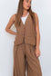 Close-up front view of a model wearing the Chocolate Prince of Wales Vest over a white tank with matching check trousers.