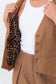 Close-up of the Chocolate Prince of Wales Vest opened to show its contrasting leopard cotton lining.