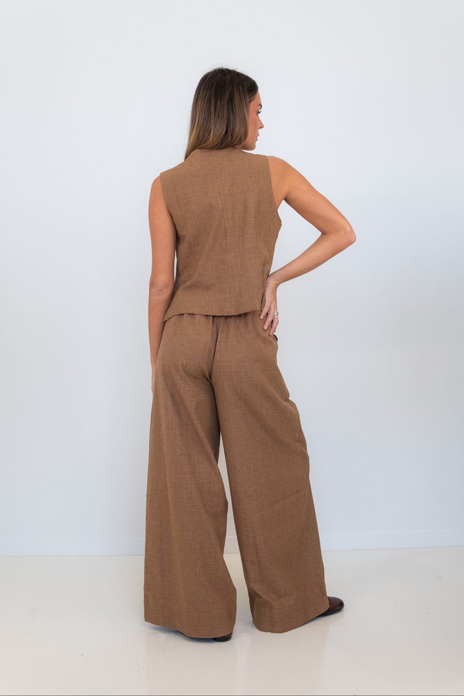 Back view of Chocolate Prince of Wales wide-leg pants styled with the matching check vest.