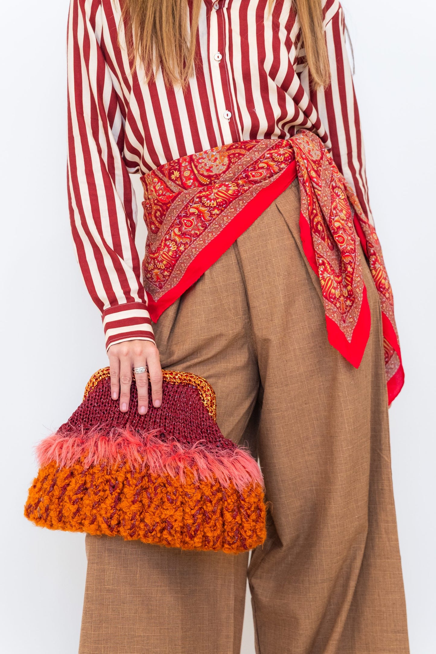 Close-up of Chocolate Prince of Wales wide-leg pants showing the check fabric, waistband, and wide-leg silhouette.