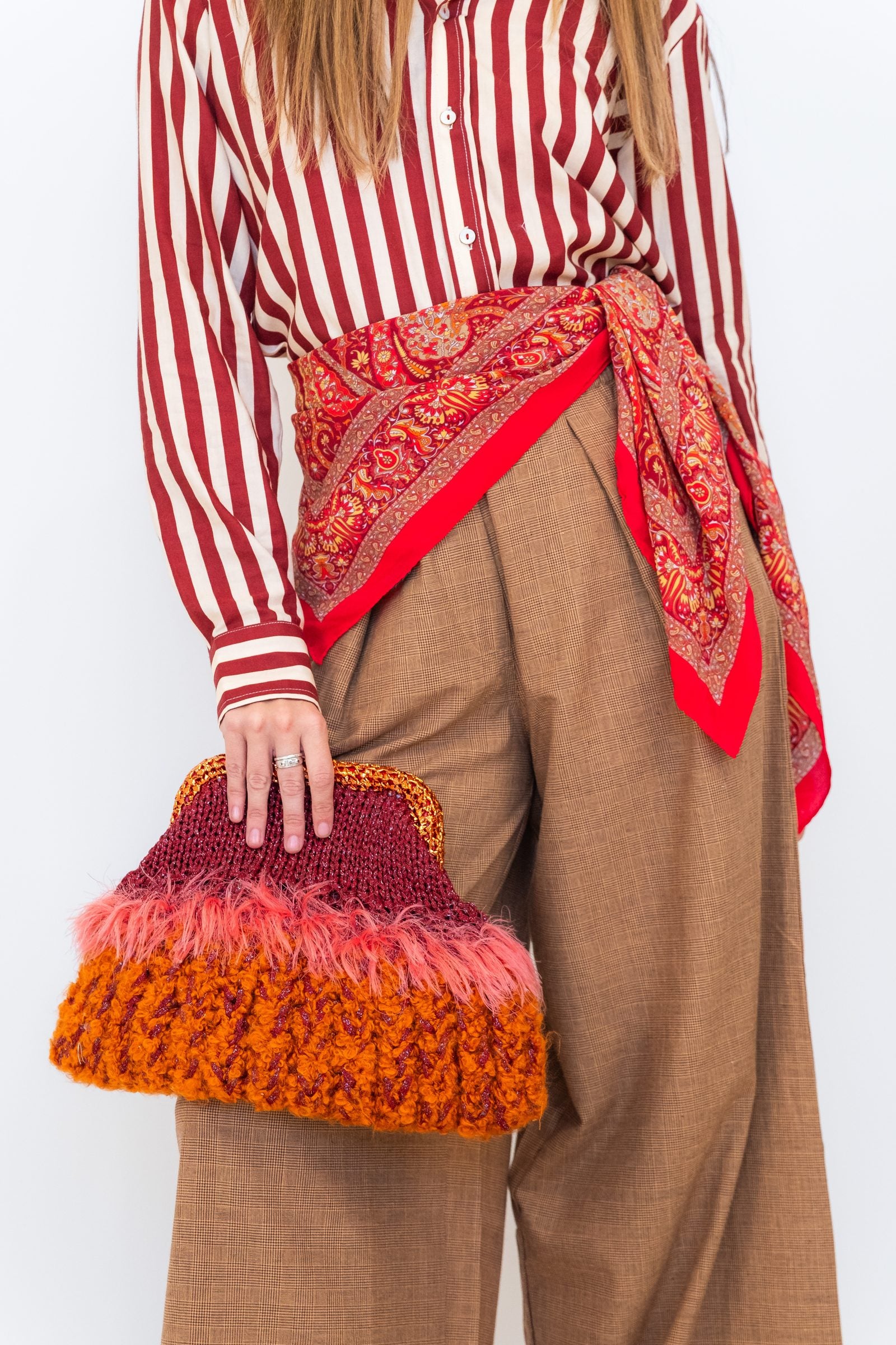 Close-up of Chocolate Prince of Wales wide-leg pants showing the check fabric, waistband, and wide-leg silhouette.