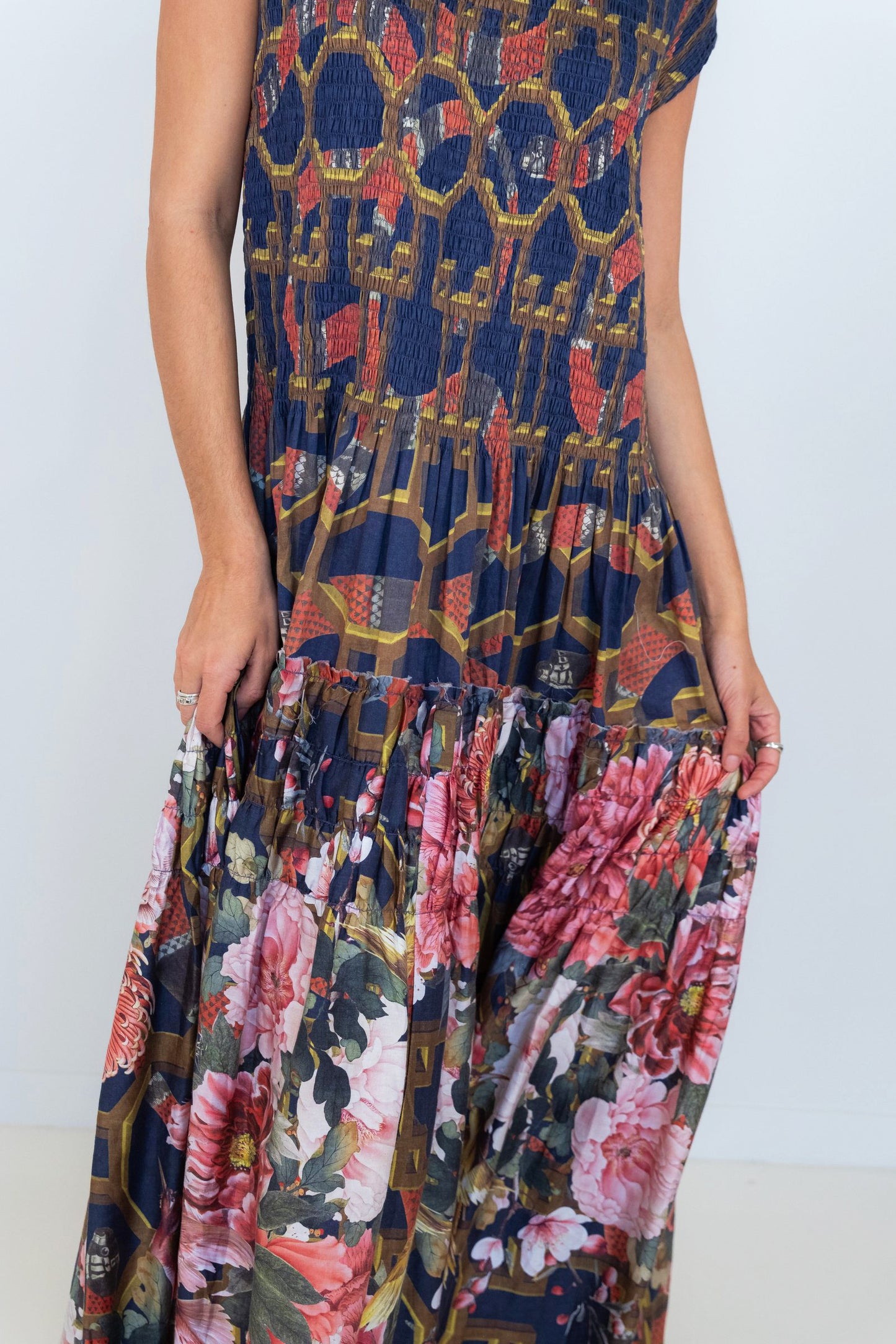 Close-up of the colourful floral print and flowing tiers on the Ophelia maxi dress skirt.