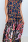 Close-up of the colourful floral print and flowing tiers on the Ophelia maxi dress skirt.