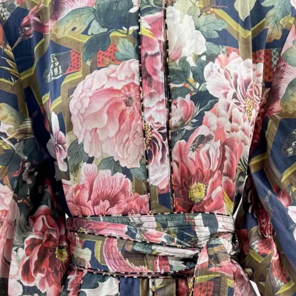 Close-up of the navy floral print, leopard piping, button-through front, and self-tie belt on the Ophelia short dress.