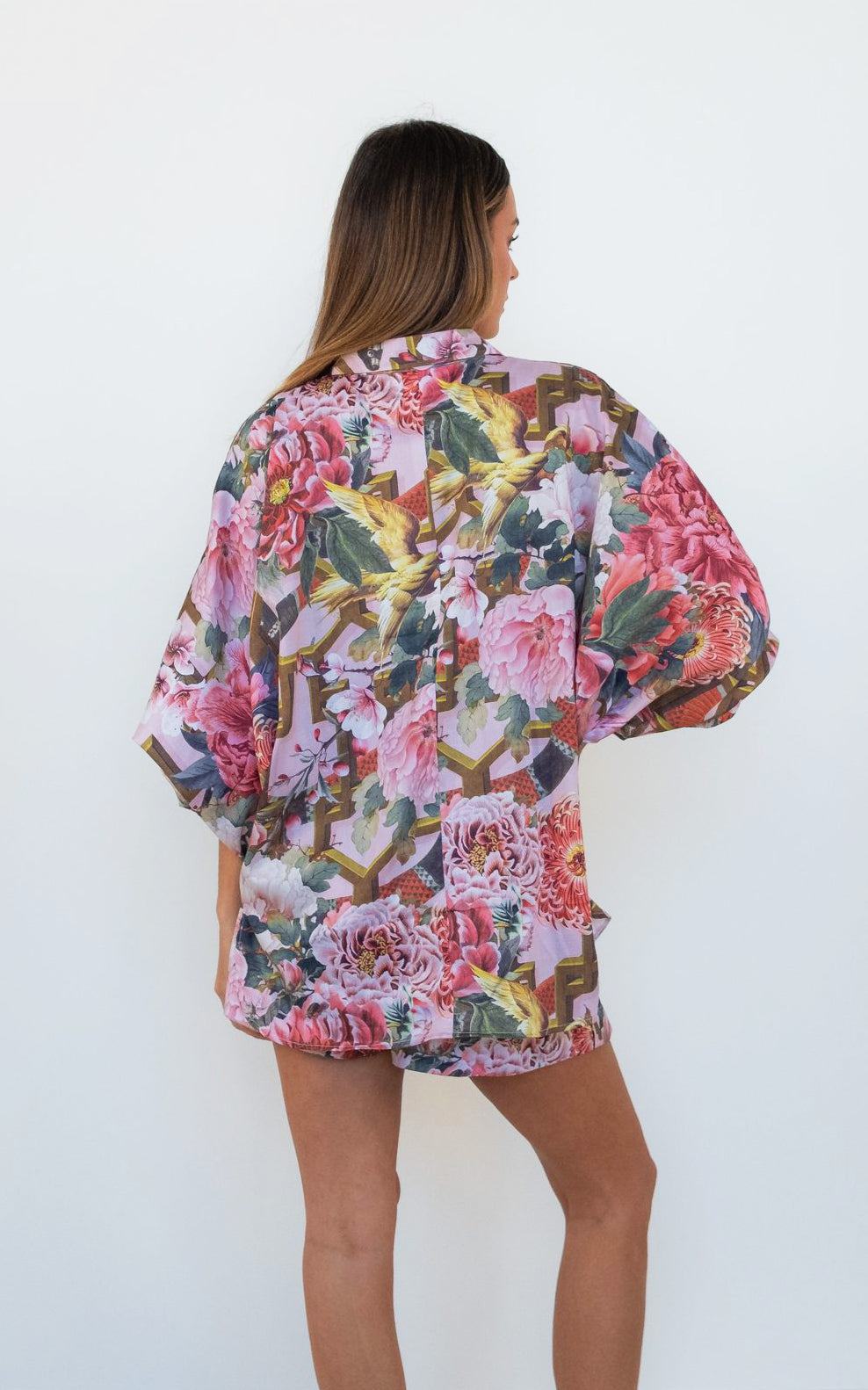 Back view of the Ophelia Pink Butterfly Shirt, showing the relaxed oversized fit and pink floral print.