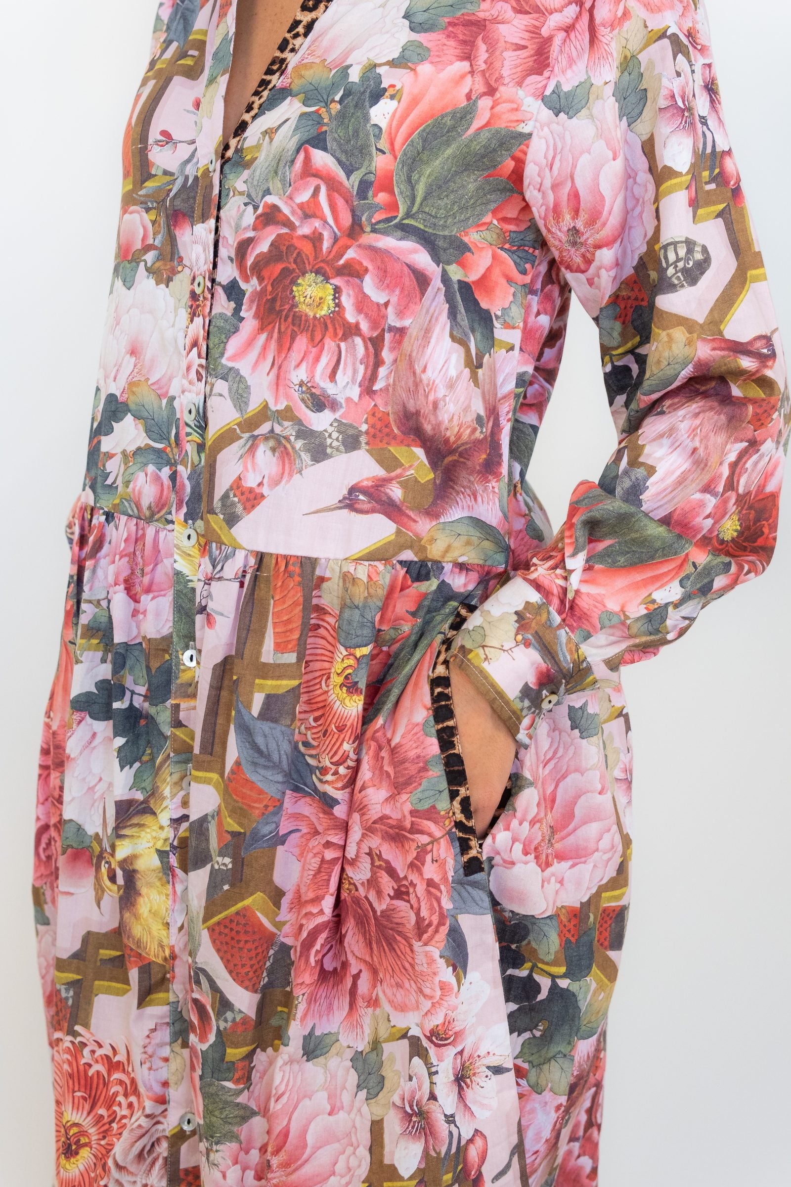 Close-up of the pocket detail and collared neckline and pink floral-and-chain print on the Ophelia drop-waist dress.