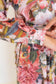 Close-up of the slim tie belt and pink floral-and-chain print at the waist of the Ophelia dress.