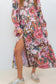 Model wearing the pink floral-and-chain print drop-waist dress with the skirt slit open.
