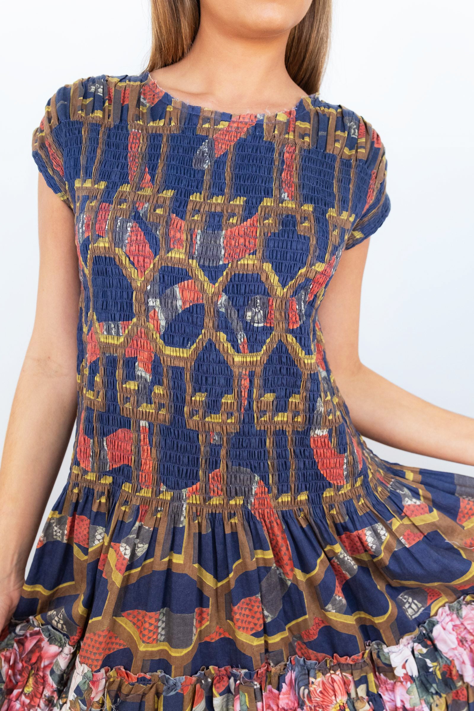 Close-up of the smocked navy patterned bodice and first tier of the Ophelia maxi dress.