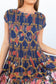 Close-up of the smocked navy patterned bodice and first tier of the Ophelia maxi dress.