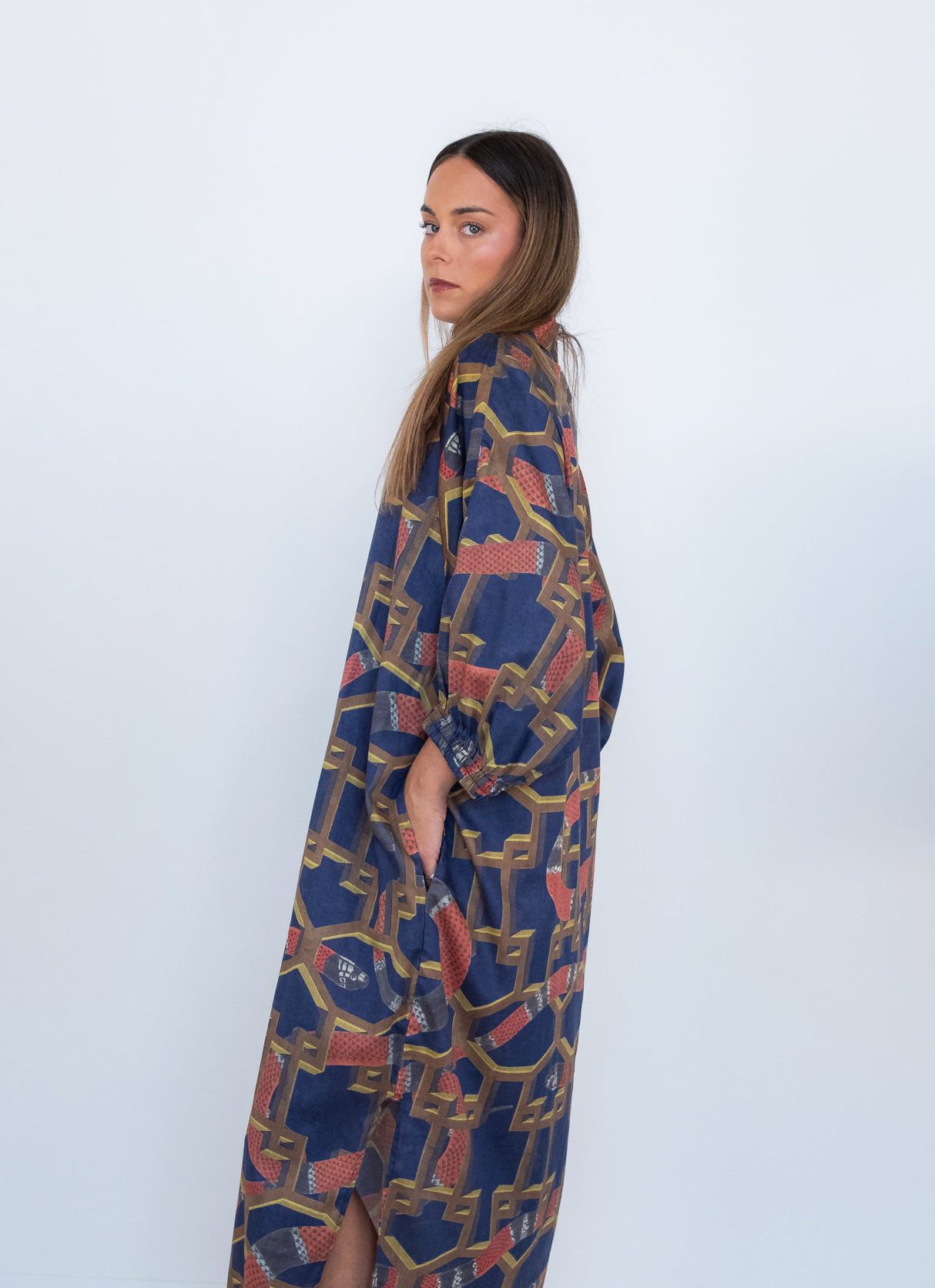 Side view of a model wearing the Ophelia Snakes Butterfly Dress with loose butterfly sleeves.