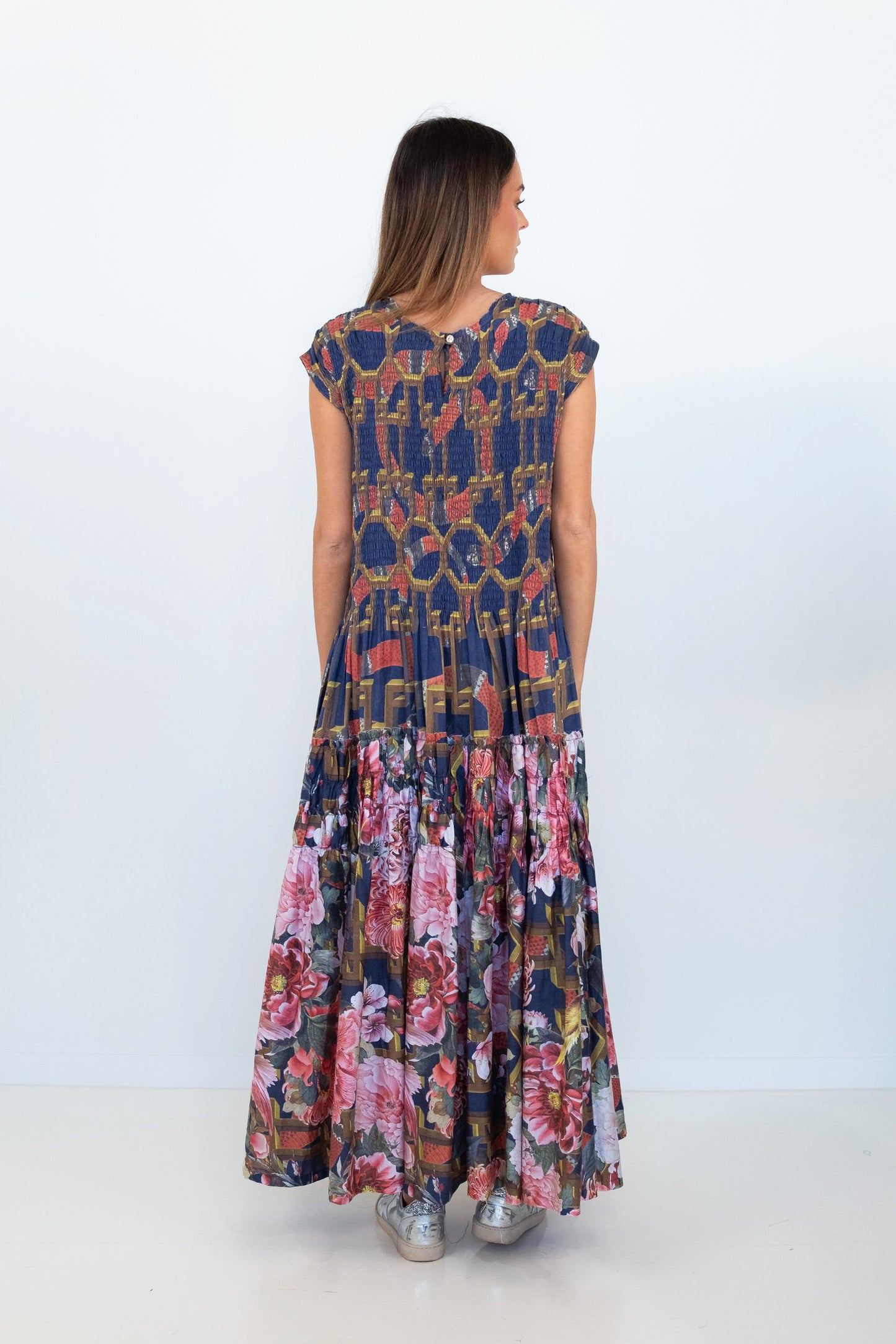 Back view of the Ophelia snakes and florals maxi dress, showing the navy patterned bodice and floral tiered skirt.