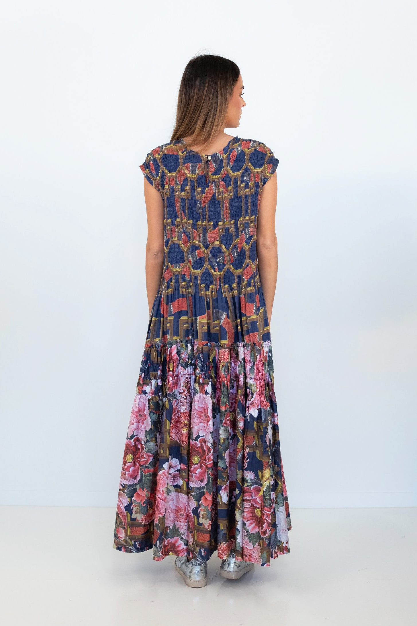 Back view of the Ophelia snakes and florals maxi dress, showing the navy patterned bodice and floral tiered skirt.