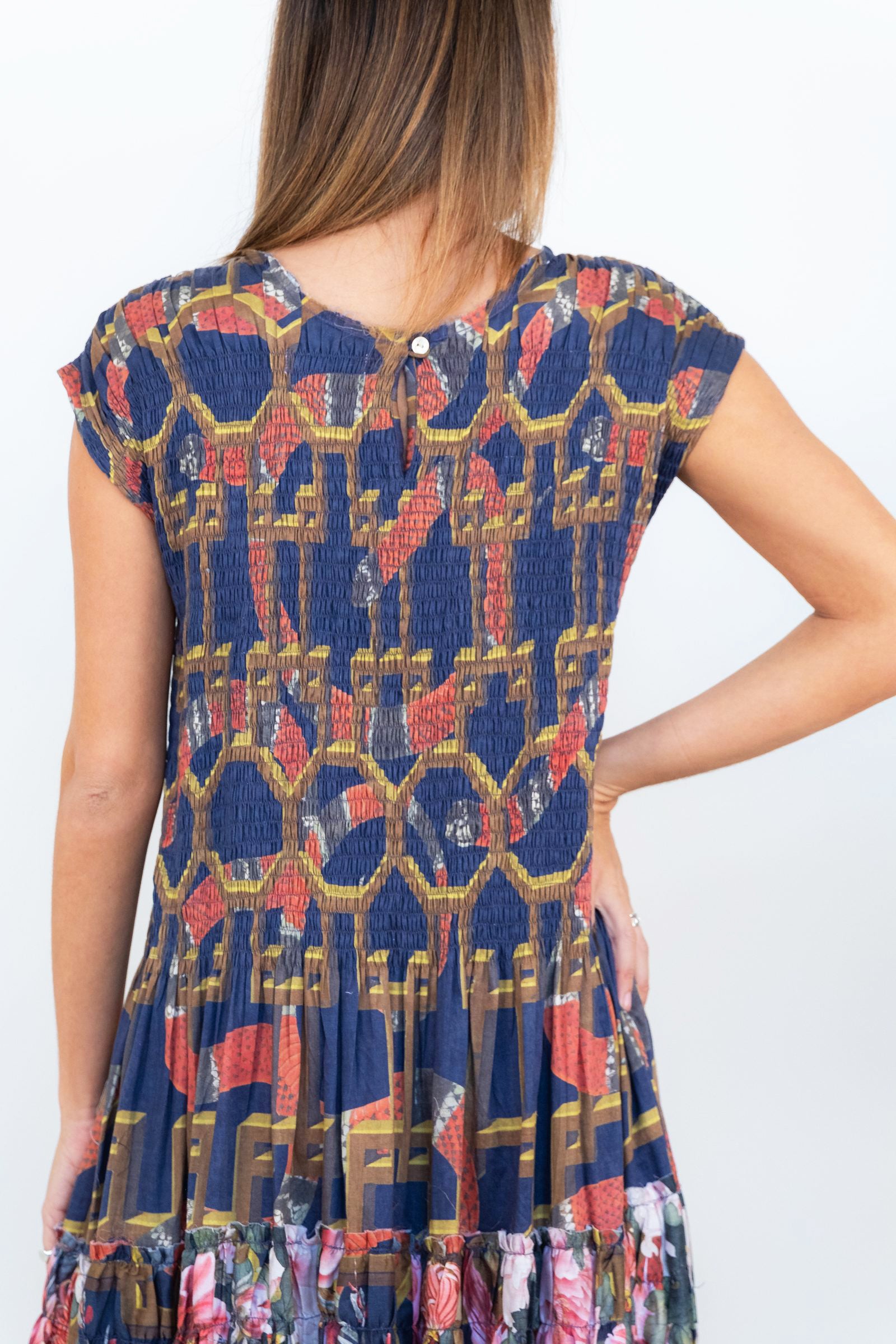 Close-up back view of the smocked bodice on the Ophelia snakes and florals maxi dress.