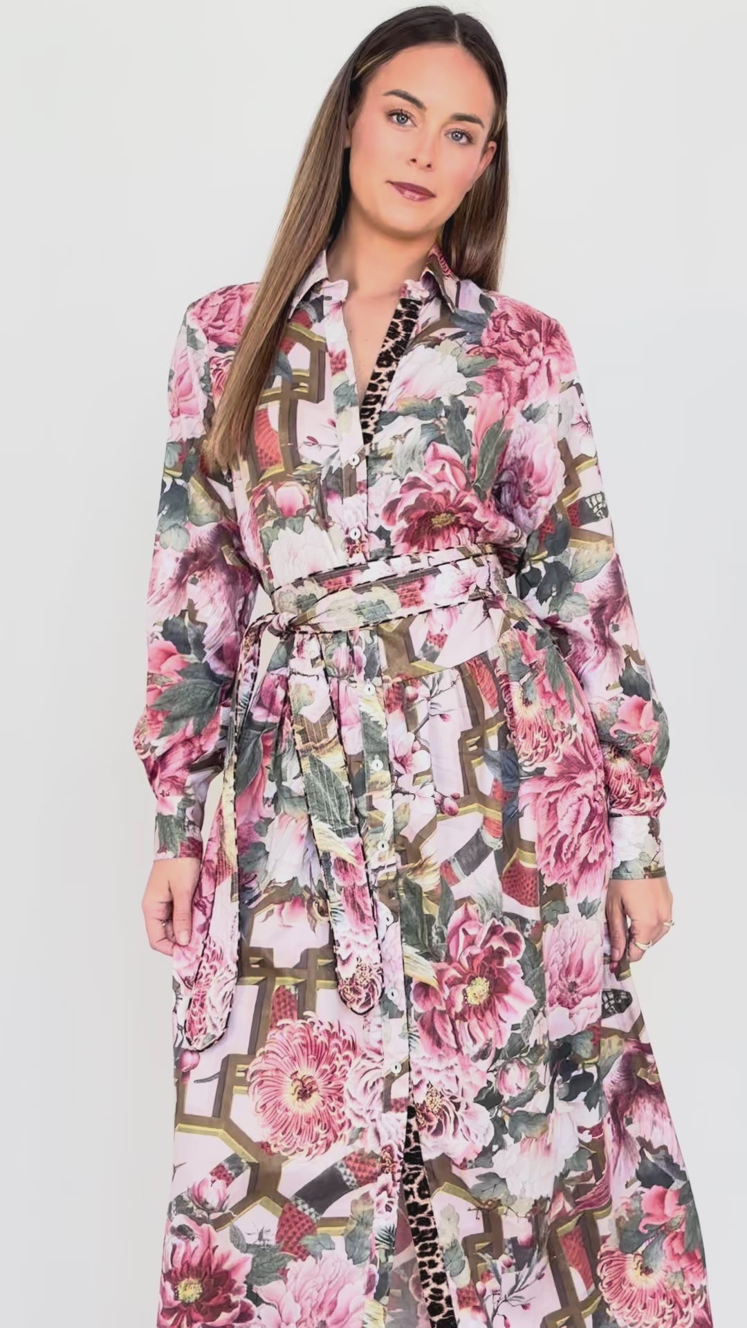 Model demonstrating the fit and movement of the Ophelia pink drop-waist dress with slim tie belt.