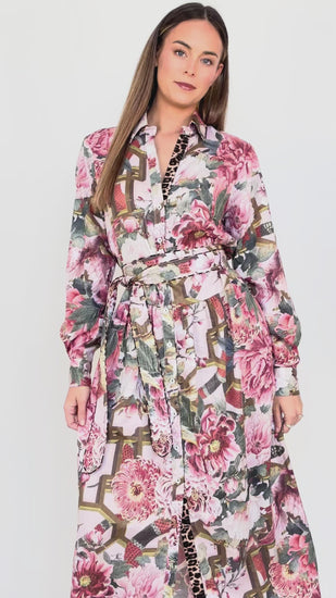 Model demonstrating the fit and movement of the Ophelia pink drop-waist dress with slim tie belt.