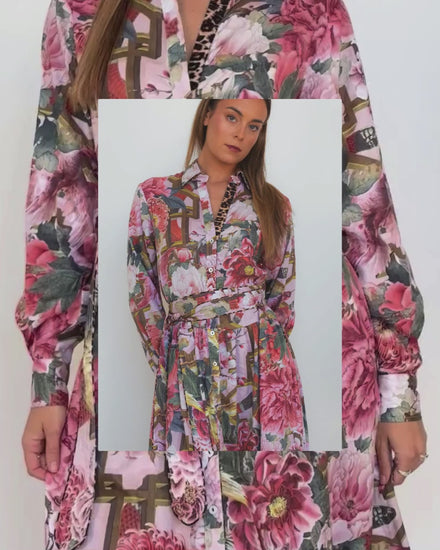 Model wearing the Ophelia pink floral-and-chain print drop-waist dress with a slim tie belt and close-up of fabric details .